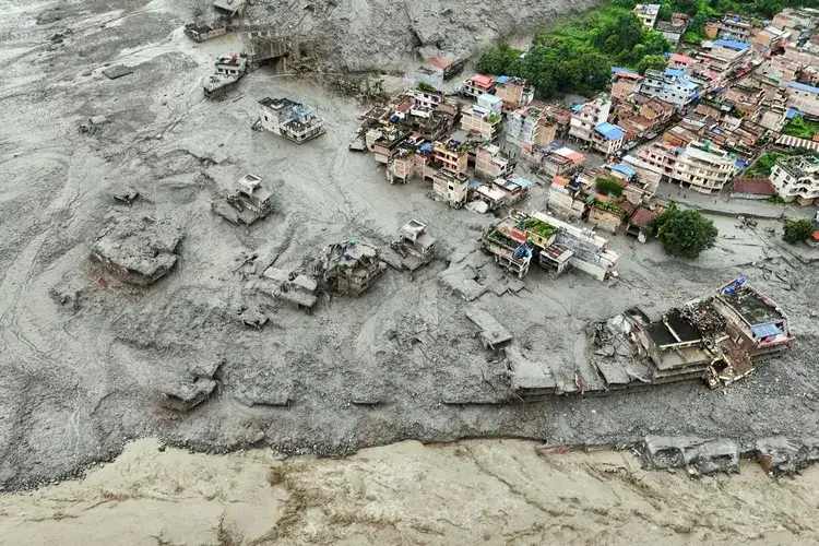 Trishuli, Nepal - August 27, 2026: A drone view shows mud covering properties following a flash flood in Trishuli, Nepal. Thick layers of debris and mud blanket homes and surrounding areas, highlighting the severe destruction caused by heavy rainfall and sudden flooding in the affected community.