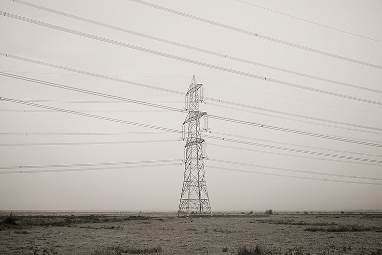 Electicity lines criss-cross the bleak landscape