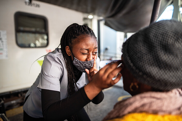 Eddnice, an optometry student, carries out an eye test. The train has 37 permanent staff but also relies on a rotating body of medical students from across the countr