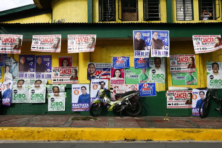 Posters of politicians are displayed on walls as part of their campaign for the upcoming May 2022 elections.