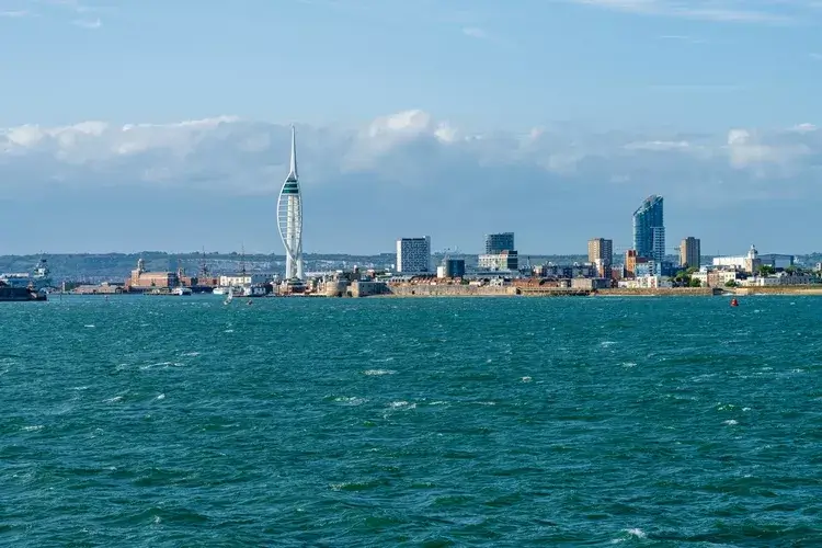 Spinnaker Tower dominates the Portsmouth skyline, overlooking the harbour in Portsmouth England seen from departing ferry