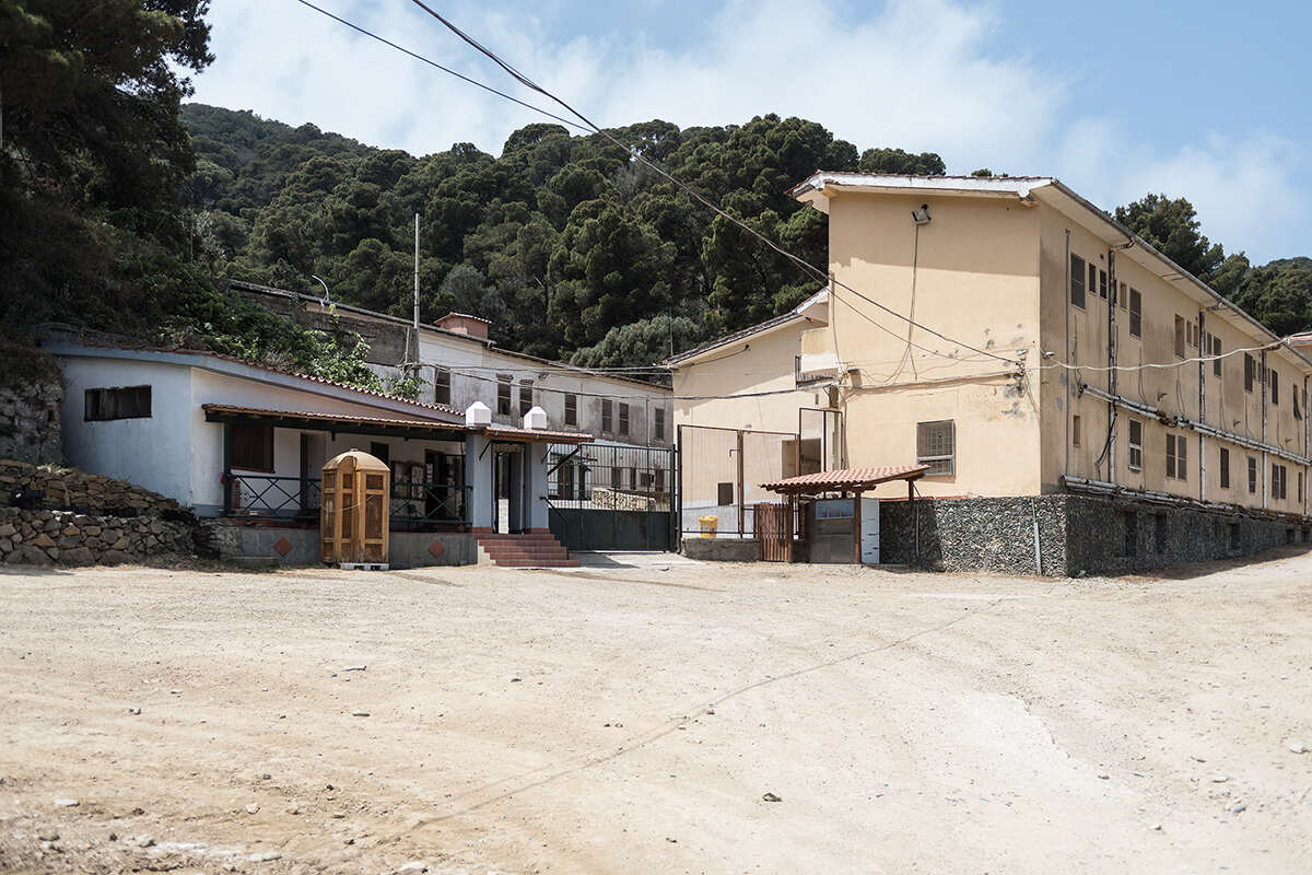 A view of the beige and white buildings which make up the prison