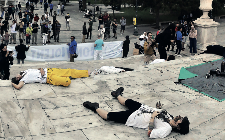 Anti-fossil-fuel protesters on the steps of the Greek parliament