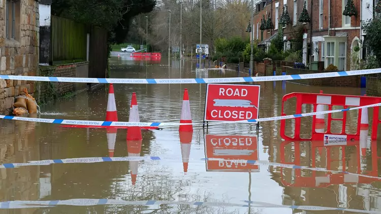 Road closed sign in flooded road