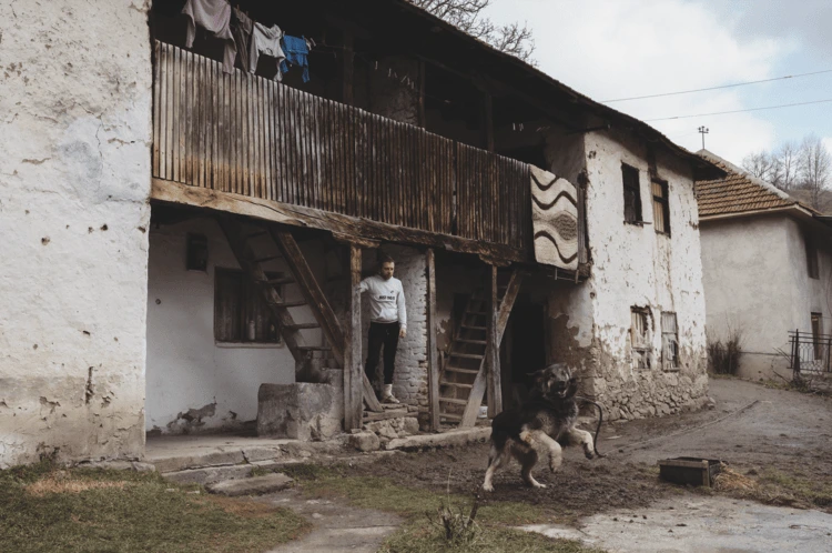 A Serb farmer with his guard dog on his farm in the Šar Mountains near Sevce