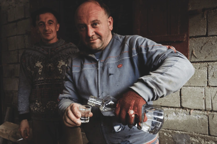 Serbian famers serve some home-distilled fruit brandy in Sevce in the Šar Mountains in southern Kosovo