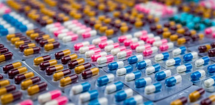 Selective focus on colorful antibiotic capsule pills in blister pack