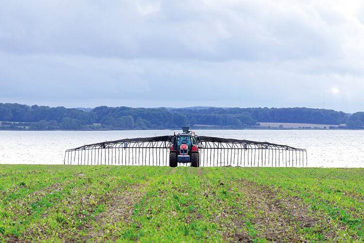 A farmer sprays slurry on a field that directly runs off into open water