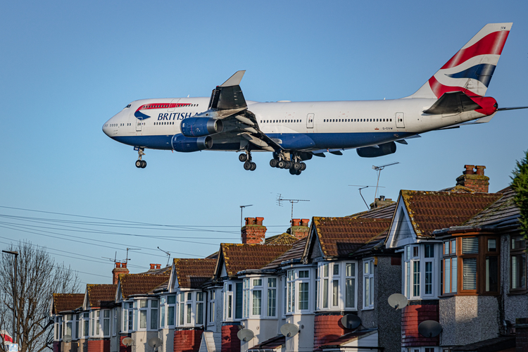 Plane going over houses