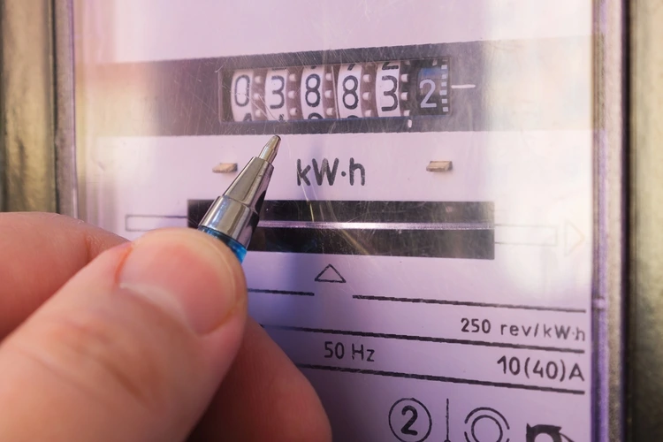 Ballpoint pen showing electricity meter readings. Distribution of electricity in an apartment building, payment of utility services.