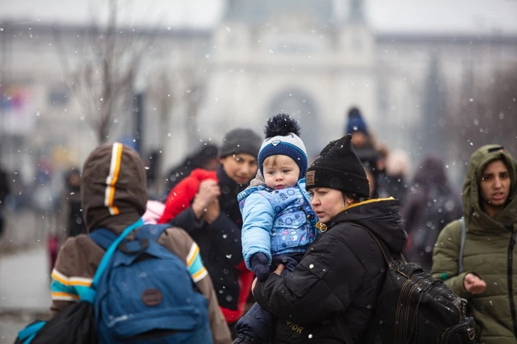 Ukrainian refugees on Lviv railway station waiting for train to escape to Europe