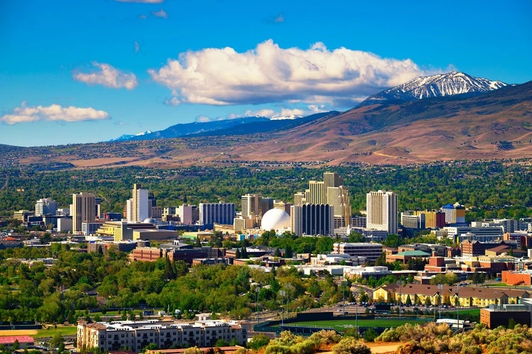 Downtown Reno skyline, Nevada, with hotels, casinos and the surrounding High Eastern Sierra foothills