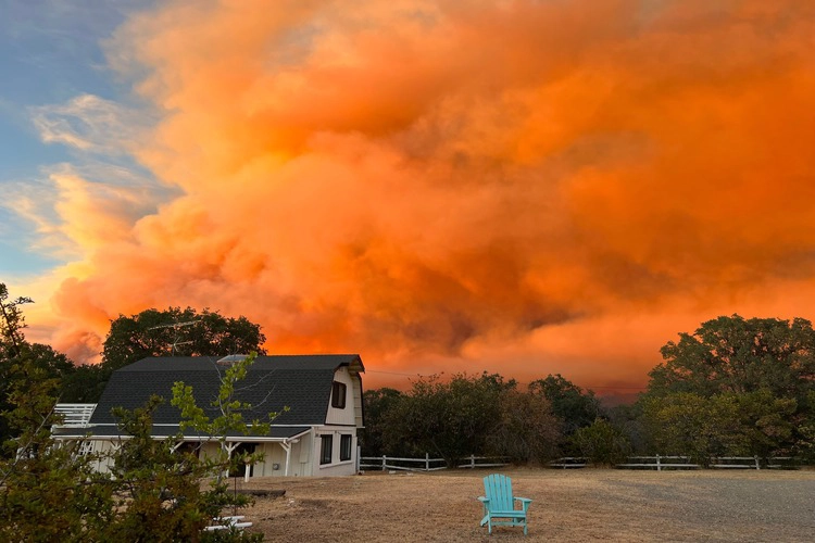 Wildfire clouds over a farm house in the Yosemite Valley, California