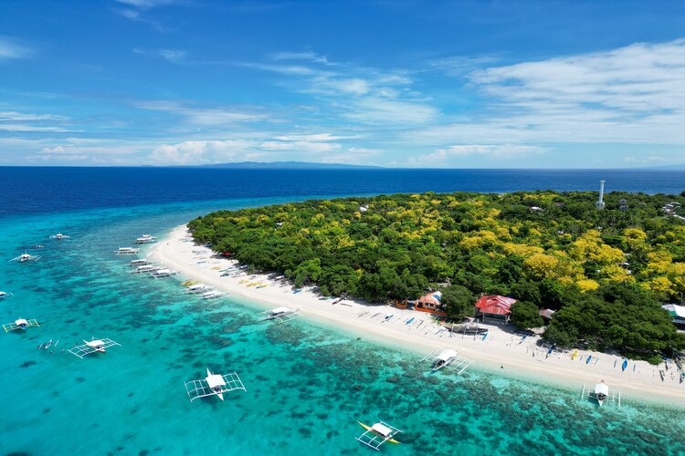 Aerial shot of Balikasak Island Scenery in Bohol, Philippines with Emerald Sea