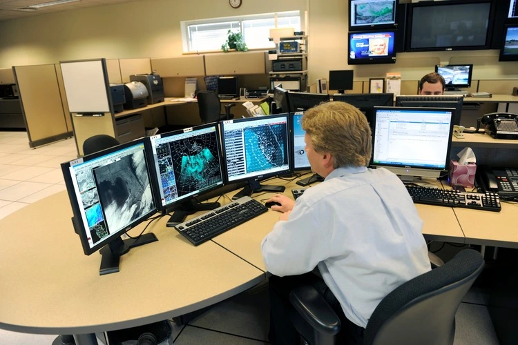 Meteorologist in work area in Doppler Radar Station with National Oceanic and Atmospheric Administration