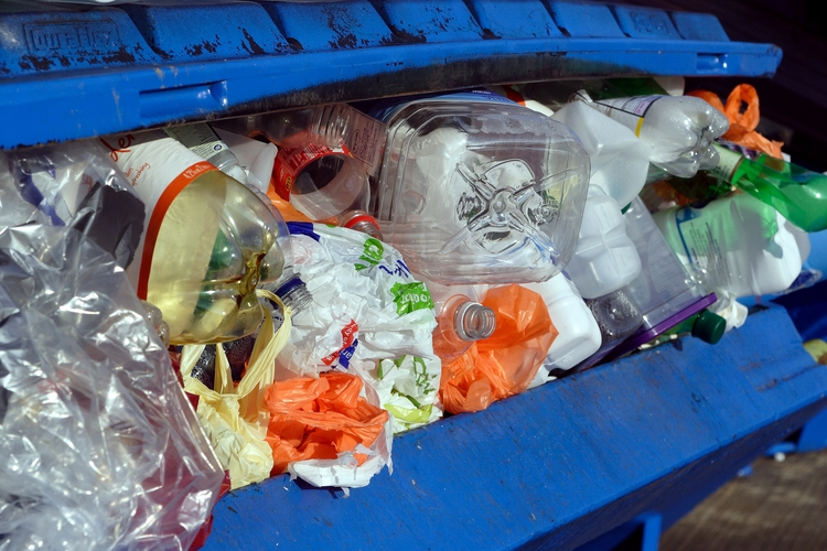 Plastic waste coming out of bin