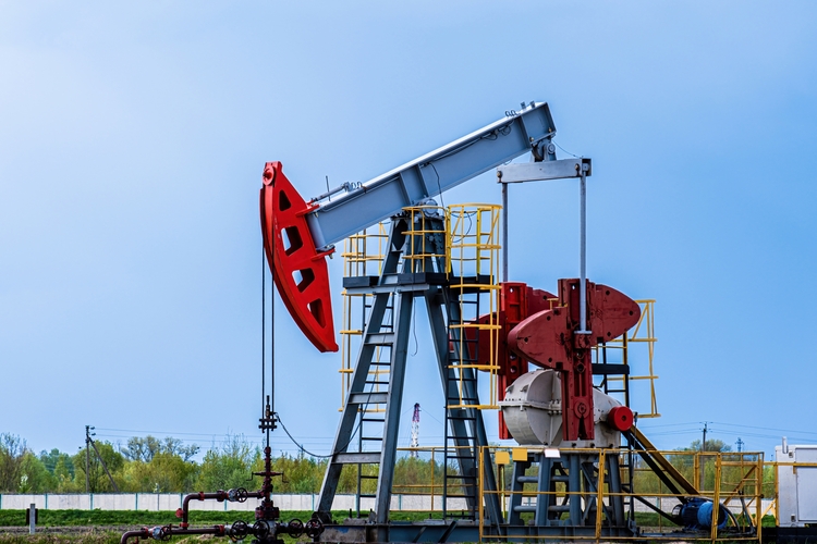 Oil drilling derrick pumps oil from ground. Petroleum industry, crude oil extraction. Production of fuel from natural resources. Oil crisis.