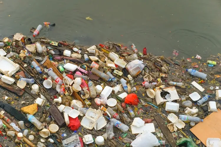 Jakarta, Indonesia - May 19, 2024: Piles of garbage in the West Flood Canal River, Jakarta.