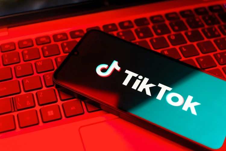 Smartphone on surface showing TikTok logo.