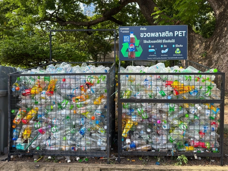 Bangkok, Thailand - June 21, 2025: Outdoor recycling bin filled with PET plastic bottles promotes environmental awareness and plastic waste management in Lumphini Park. High quality photo