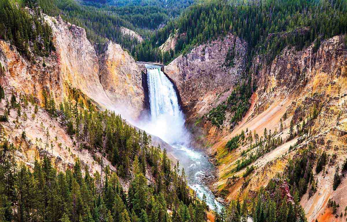 A waterfall flows through a valley of Yellowstone National Park in the USA