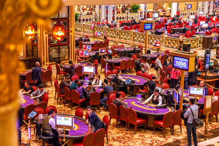 Macau, China - December 9, 2016: aerial view of blackjack tables and gamblers inside The Venetian Casino in Macau. Macau is the capital of casinos and Asian gambling and, now, in the world.