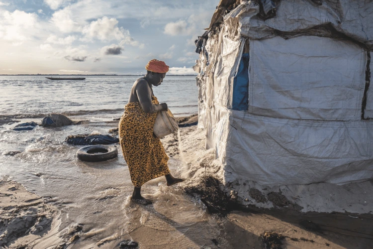 Building a sand barrier around a family home in Sierra Leone