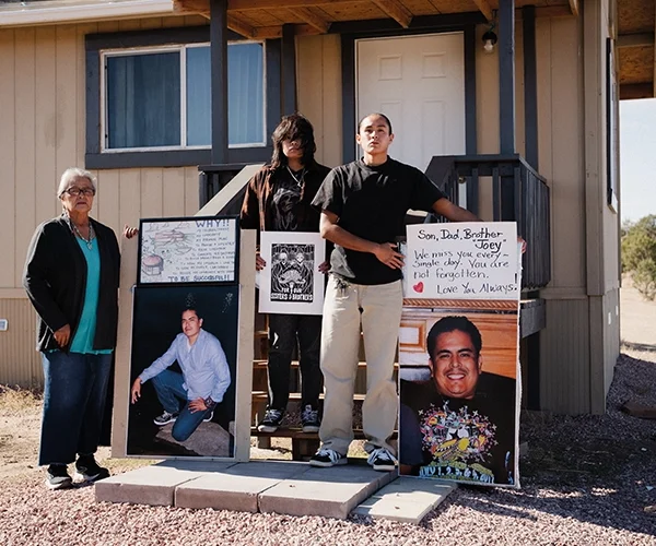 Joey Apachee’s family stands in front of the house he started building for himself and his two children before his death. From left to right: Joe’s mother, Virginia Apachee, daughter, Ashton, and son, Julian