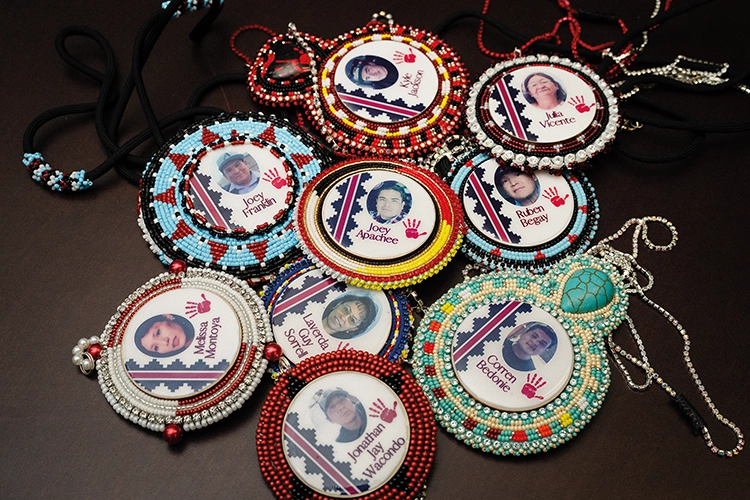 Beaded medallions featuring photographs of missing or murdered Indigenous people