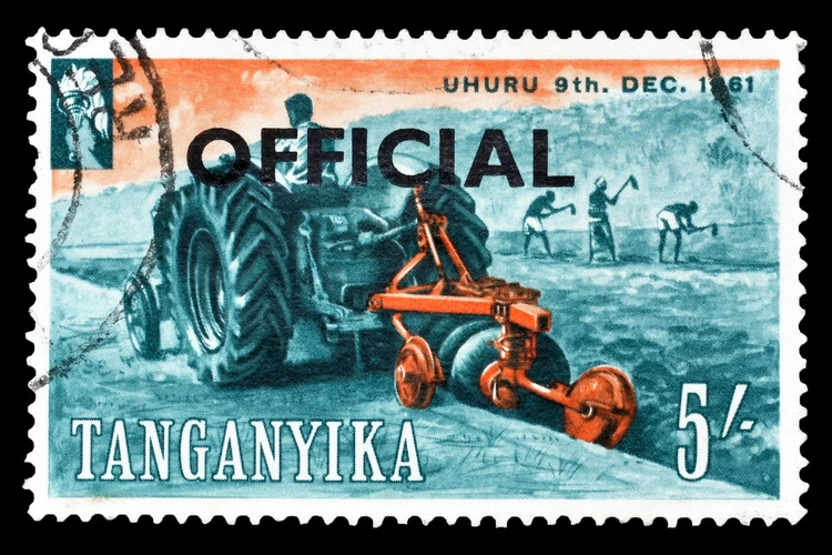 TANGANYIKA - CIRCA 1961: Postage stamp printed by Tanganyika, which shows people cultivating the land with official surcharge, circa 1961.