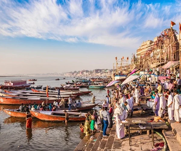 Panoramic view of the sacred city of Varanasi with people praying and taking morning bath at the Ganges River.