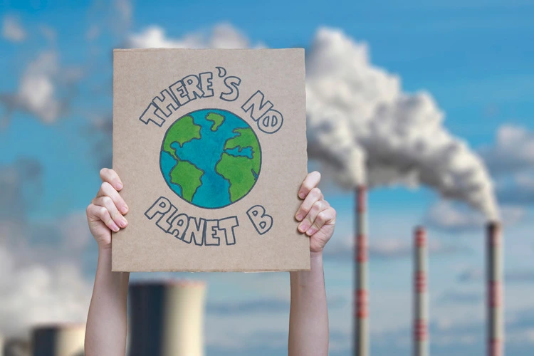 Climate change manifestation poster on an industrial fossil fuel burning 