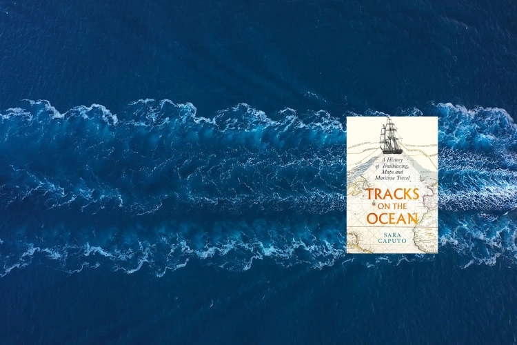 Tracks On The Ocean book in front of ocean.