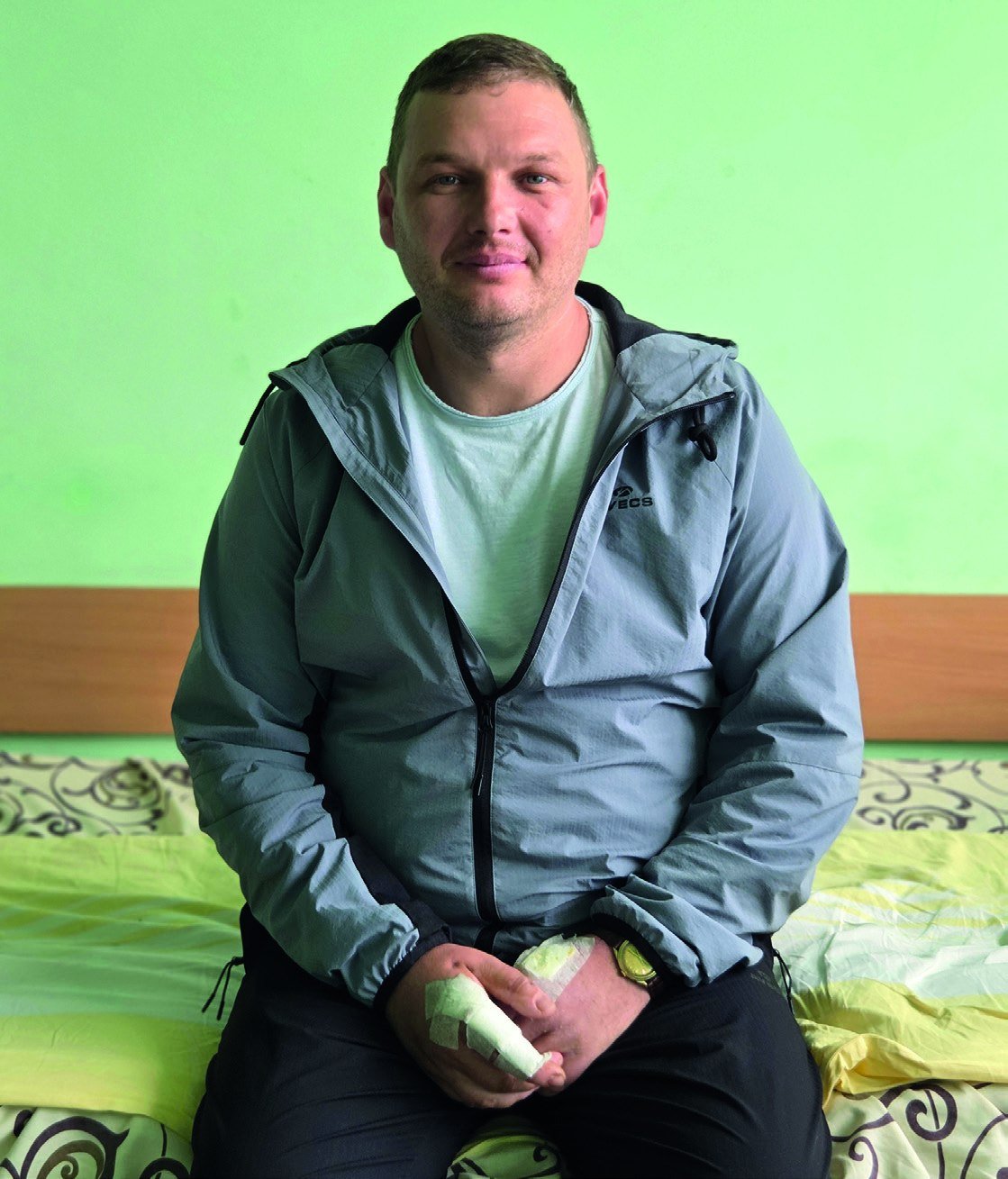 Yevgeny Beskid sitting on a hospital bed