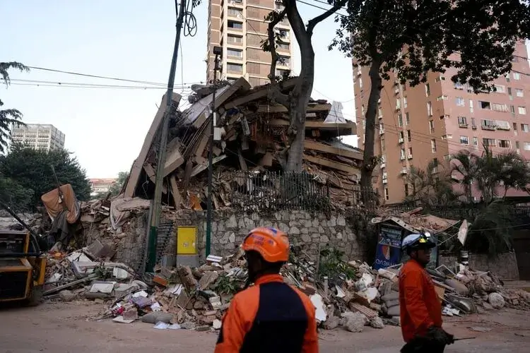 Emergency services work at the site of a collapsed building after powerful earthquakes struck Venezuela.