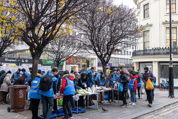 Volunteers distribute food to homeless people in London, UK