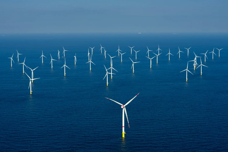 Aerial view of offshore windmill park at sea.